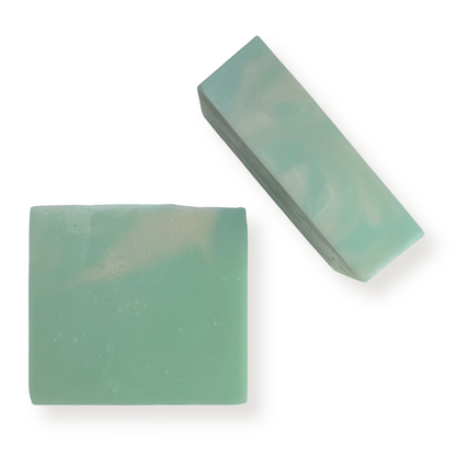 Two rectangular bars of handmade soap in a light mint green color with subtle white swirls, displayed on a clean white background.