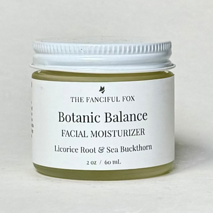 Facial moisturizer jar labeled 'Botanic Balance' by 'The Fanciful Fox' on a light gray background